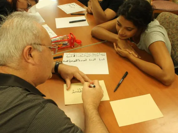 man writing on paper