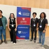 Students and Dr. MBarki standing around the QatarDebate sign