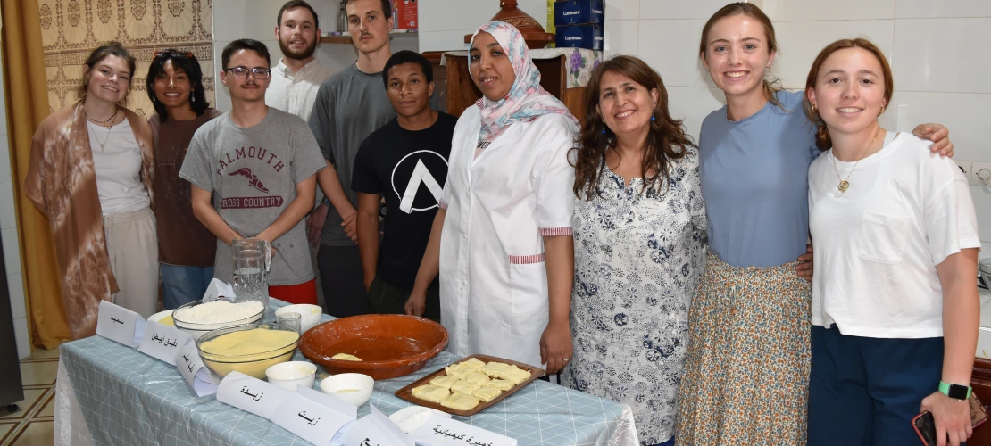 A group of students and community members in a kitchen.